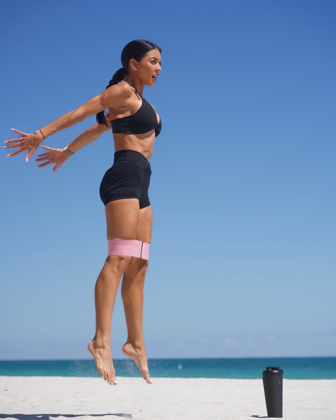 Melissa jumping on the beach